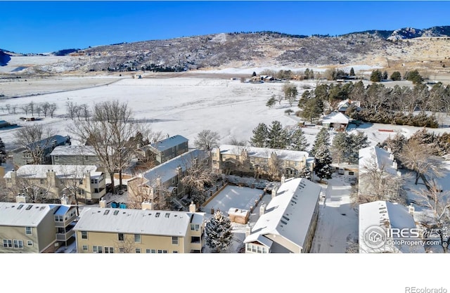 snowy aerial view featuring a mountain view