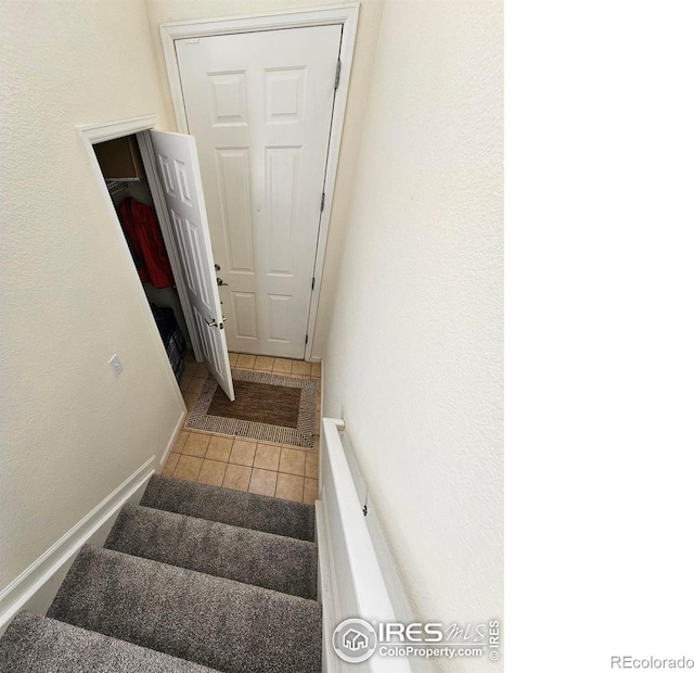 stairs featuring tile patterned floors