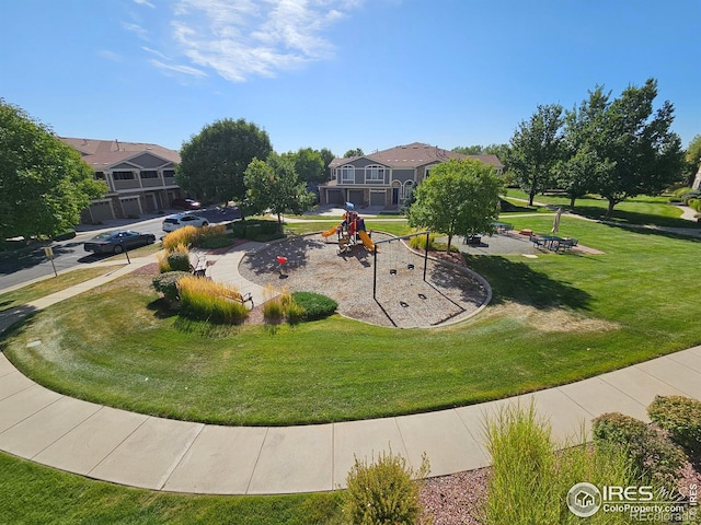 view of community featuring a playground and a yard