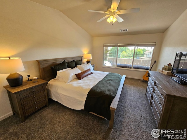 bedroom featuring ceiling fan, vaulted ceiling, and dark colored carpet