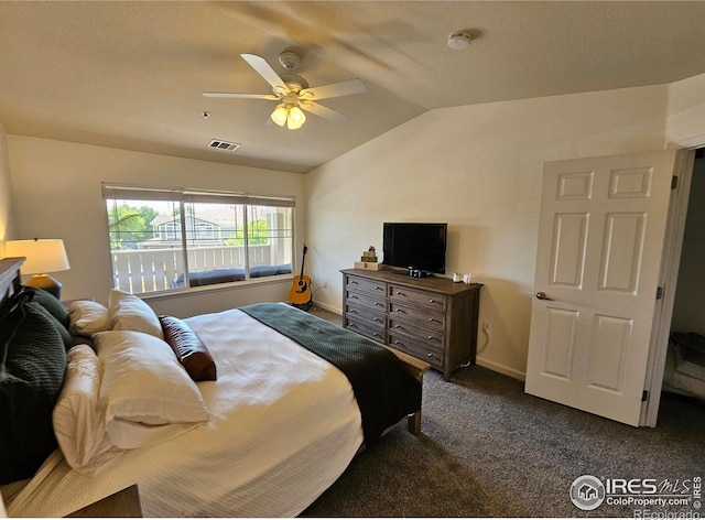 bedroom featuring ceiling fan, dark carpet, and vaulted ceiling