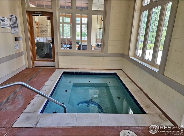 view of pool featuring an indoor hot tub