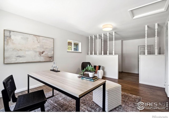 office area with wood finished floors, attic access, and baseboards