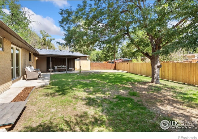 view of yard with a fenced backyard and a patio