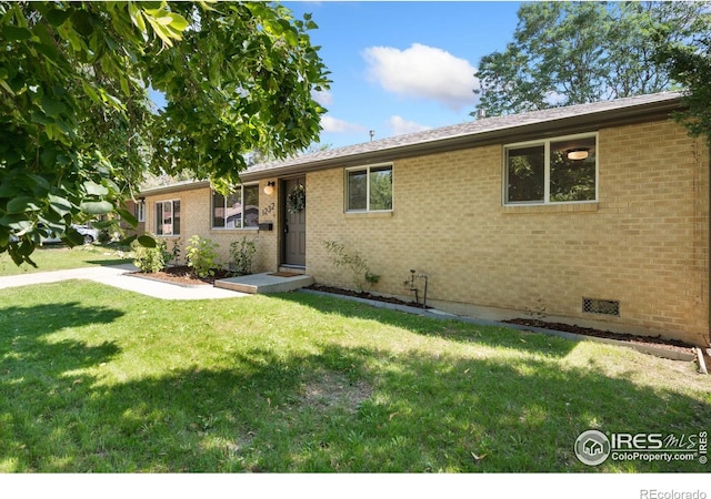 single story home with crawl space, brick siding, and a front lawn