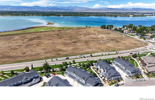 bird's eye view with a water and mountain view