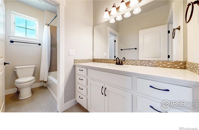 full bathroom featuring toilet, tile patterned flooring, vanity, and shower / tub combo with curtain