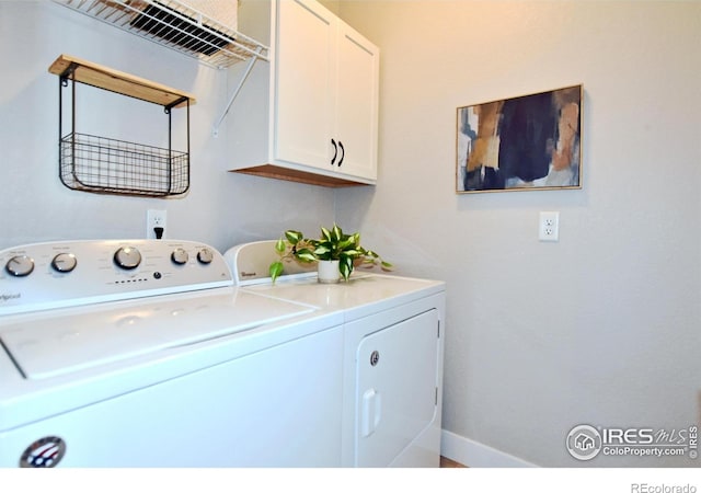 laundry room featuring washing machine and dryer and cabinets