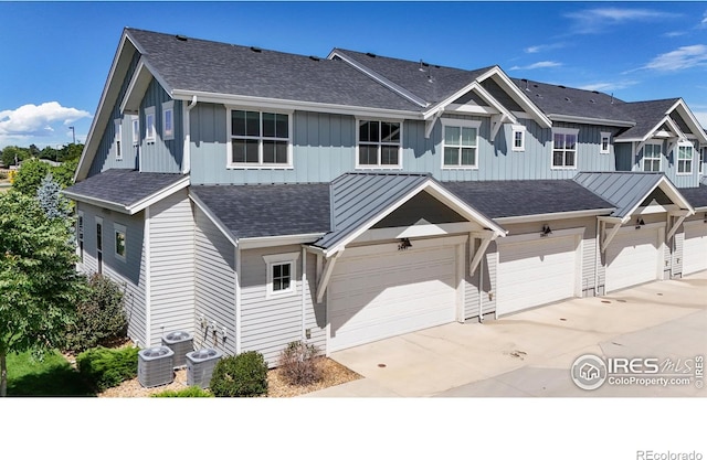 view of front facade with a garage and central AC