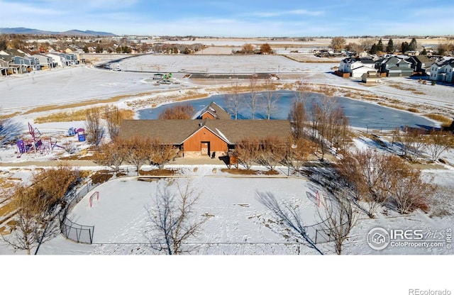 snowy aerial view with a mountain view