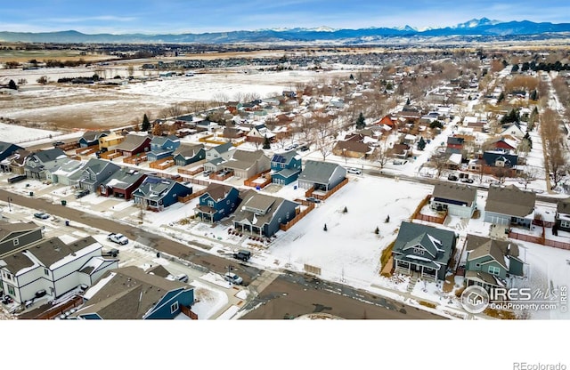 snowy aerial view featuring a mountain view