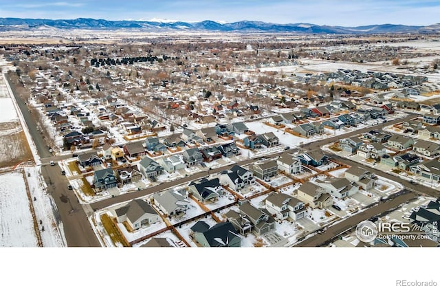 snowy aerial view with a mountain view