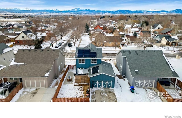 snowy aerial view with a mountain view