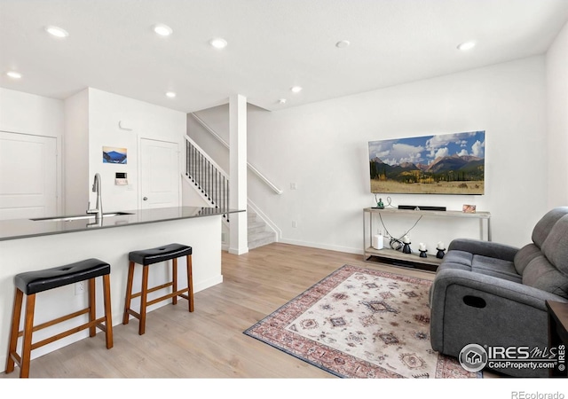 living room featuring light hardwood / wood-style flooring and sink