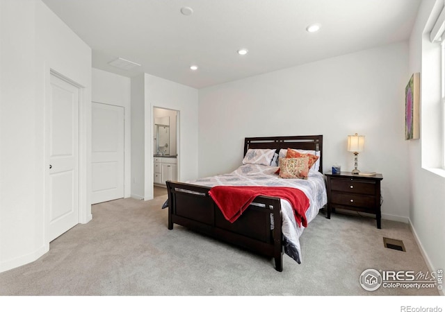 carpeted bedroom with ensuite bath