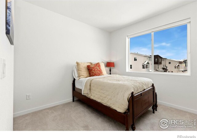 bedroom with light carpet