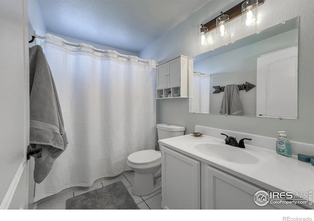 bathroom featuring toilet, vanity, and tile patterned floors