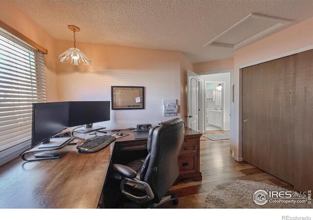 office space with wood-type flooring and a textured ceiling