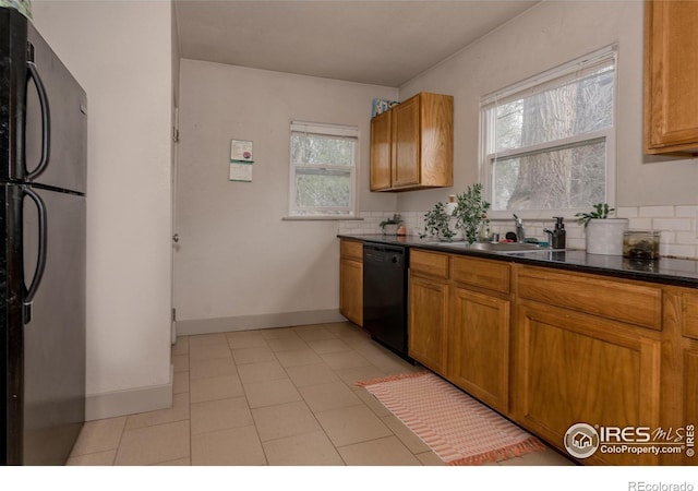 kitchen with decorative backsplash, sink, plenty of natural light, and black appliances