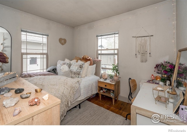 bedroom with dark wood-type flooring