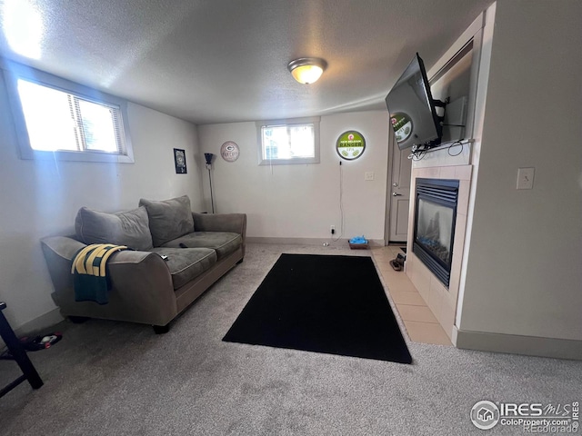 living room with light carpet, a fireplace, and a textured ceiling