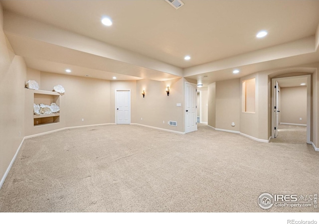 basement featuring light colored carpet