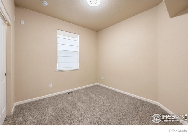 spare room featuring carpet flooring