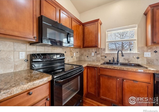 kitchen with black appliances, tasteful backsplash, and sink