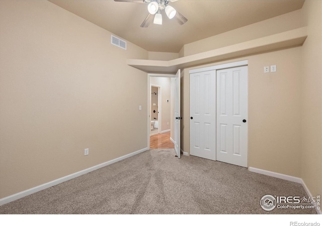 unfurnished bedroom with a closet, ceiling fan, and carpet