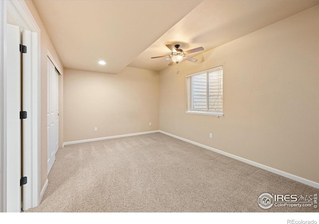 unfurnished bedroom with ceiling fan and light colored carpet