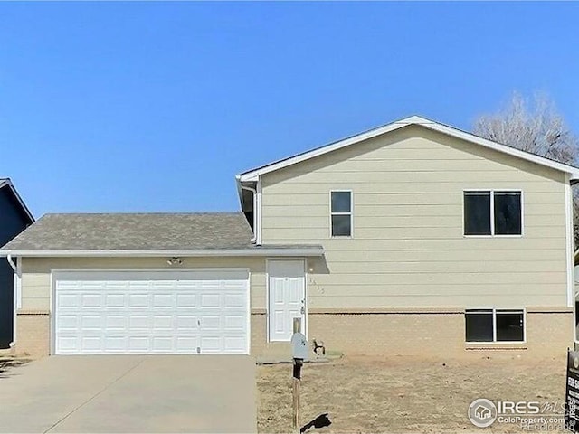 view of side of property featuring driveway and an attached garage