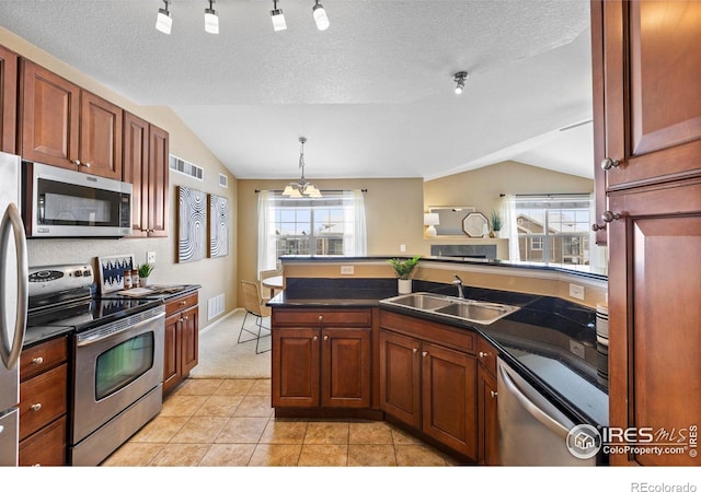 kitchen with lofted ceiling, sink, hanging light fixtures, a notable chandelier, and stainless steel appliances