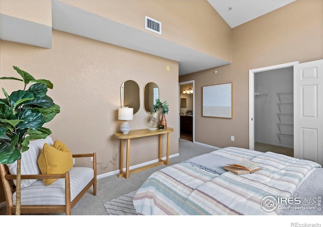 carpeted bedroom with a spacious closet, a closet, and ensuite bathroom