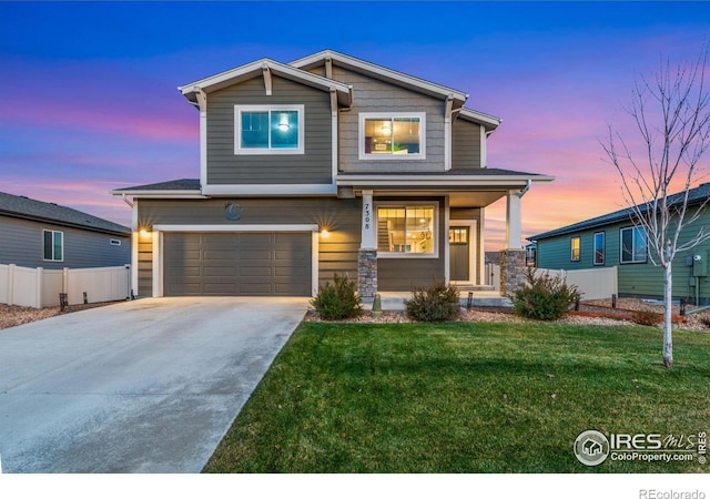 craftsman-style house featuring a garage and a lawn