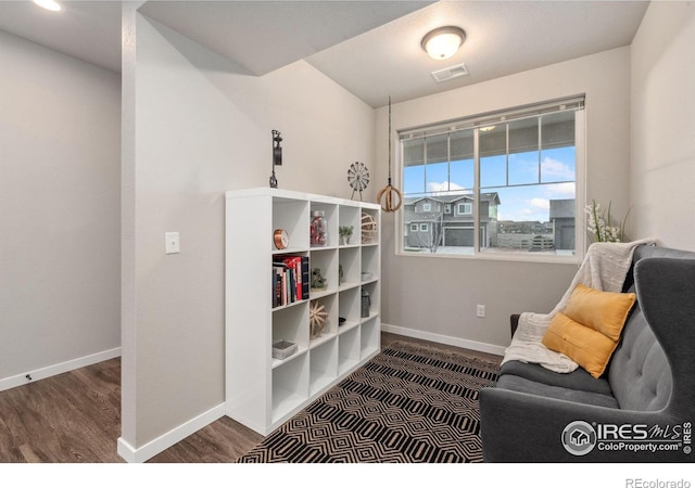 sitting room featuring dark wood-type flooring