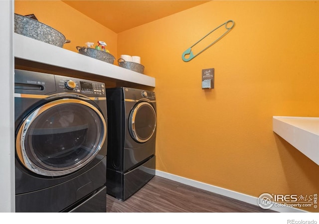 clothes washing area featuring separate washer and dryer and dark hardwood / wood-style floors