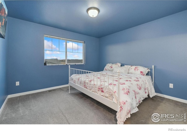 bedroom featuring dark colored carpet