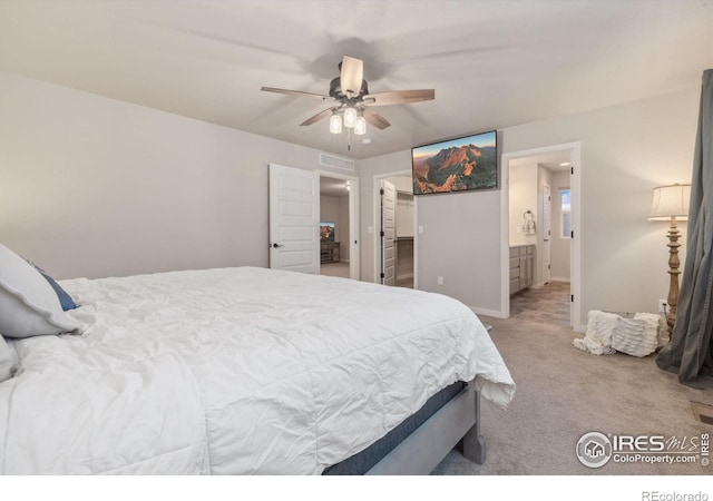 carpeted bedroom featuring connected bathroom and ceiling fan