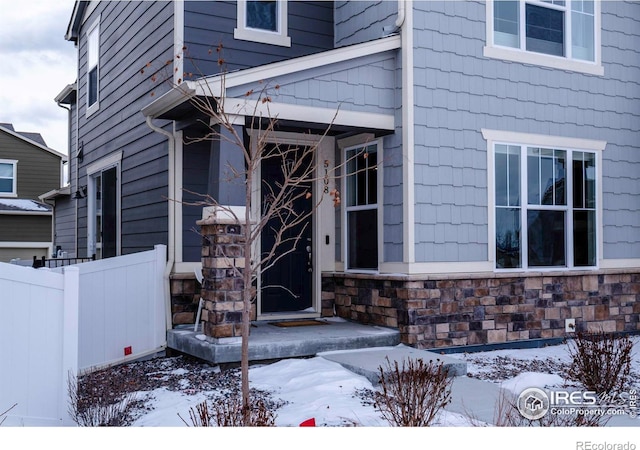 view of snow covered property entrance