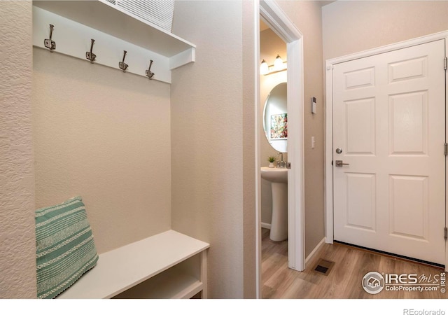 mudroom with light hardwood / wood-style flooring