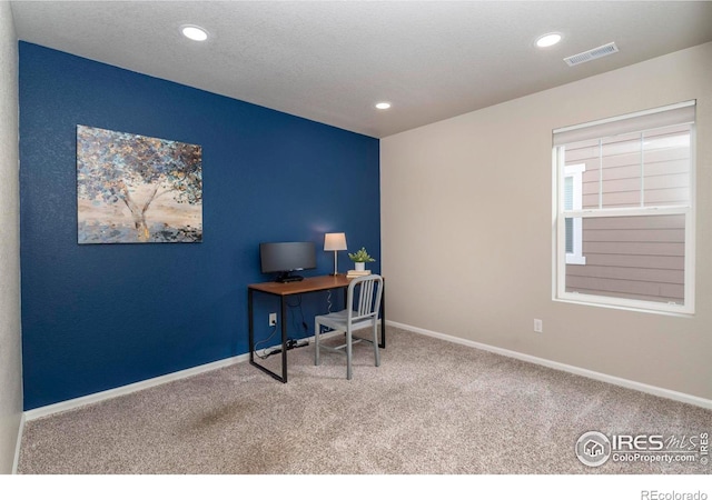 home office with carpet flooring and a textured ceiling