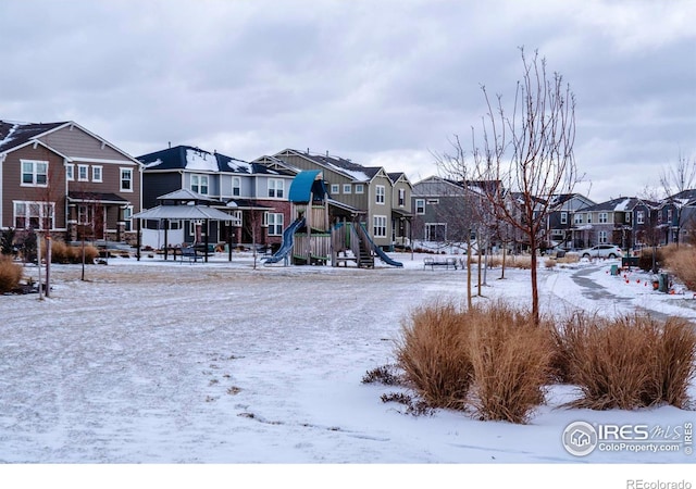 snowy yard with a playground