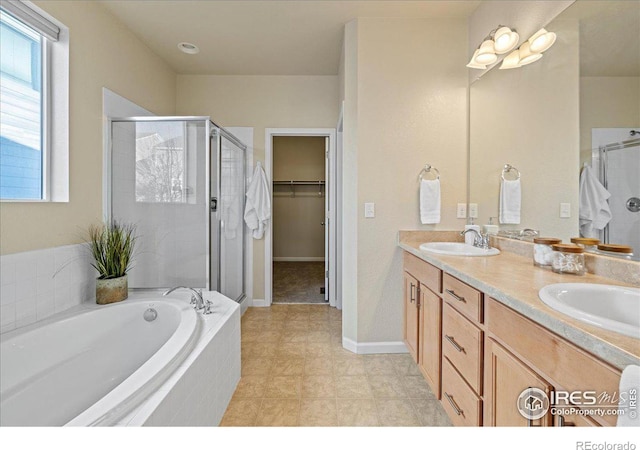 bathroom with vanity and separate shower and tub