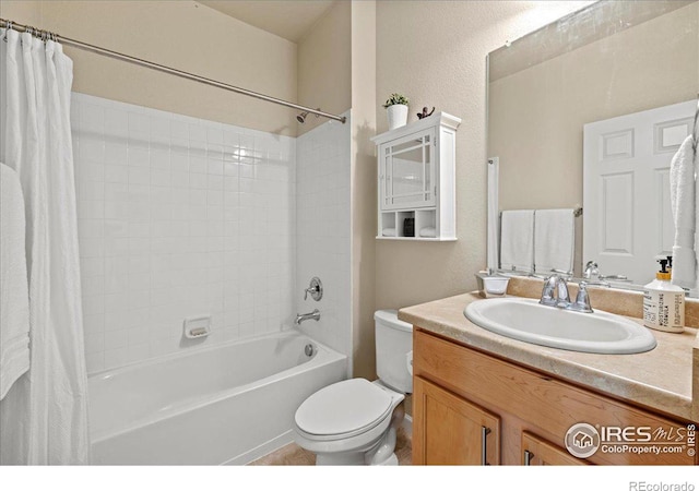 full bathroom with vanity, shower / tub combo, and toilet