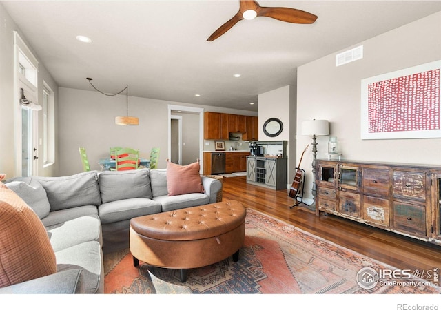 living room with dark hardwood / wood-style floors and ceiling fan