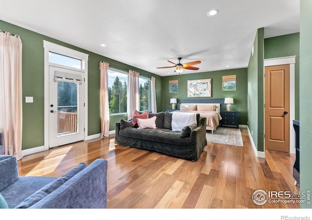 bedroom with access to outside, ceiling fan, and light hardwood / wood-style flooring