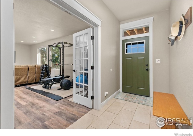 foyer entrance with light tile patterned floors