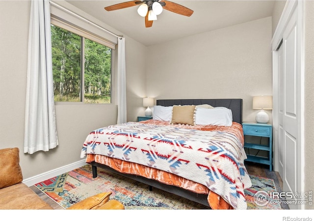 bedroom with ceiling fan and a closet