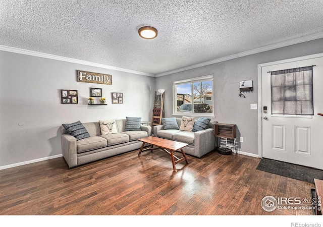 living room with dark hardwood / wood-style flooring, a textured ceiling, and ornamental molding