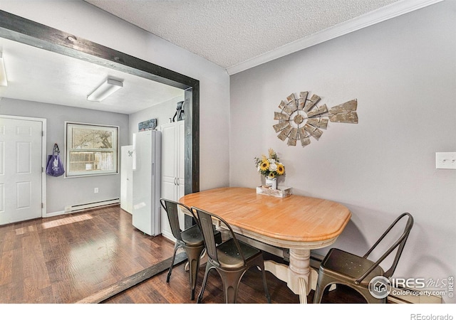 dining room with a textured ceiling, dark hardwood / wood-style floors, and baseboard heating